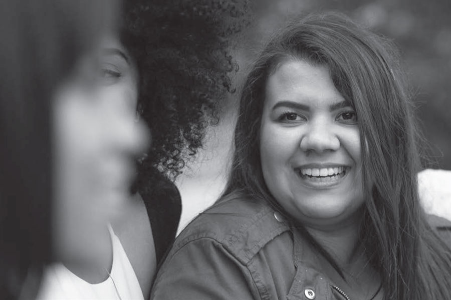 black and white close up image of teenage girls smiling