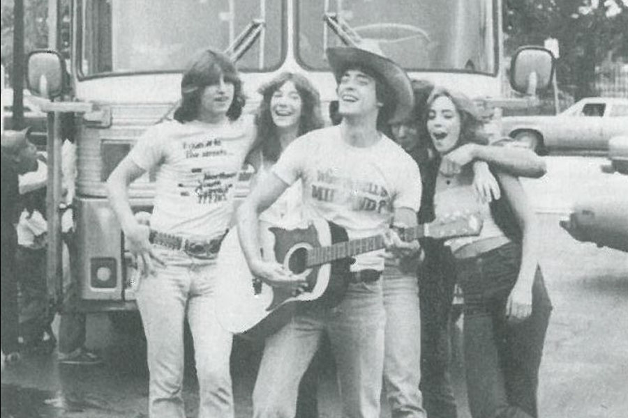Image from the 1970's of YOS teens singing together and playing guitar