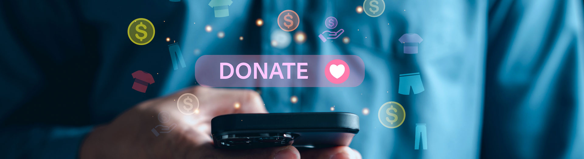 A person's hands holding a smartphone with a digital "DONATE" button and heart icon displayed on screen, surrounded by various floating icons representing money and clothing, symbolizing online charitable giving